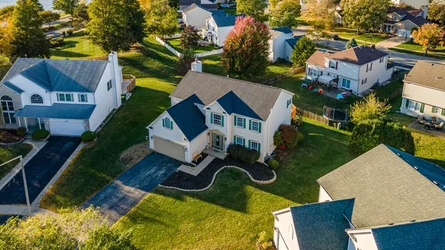 an aerial view of a house with garden space and street view