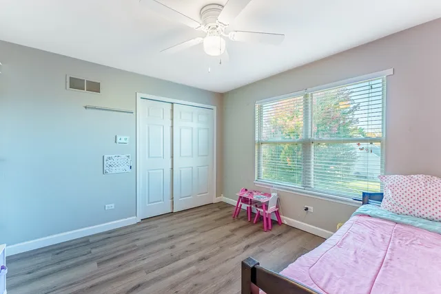 a bedroom with bed and a window