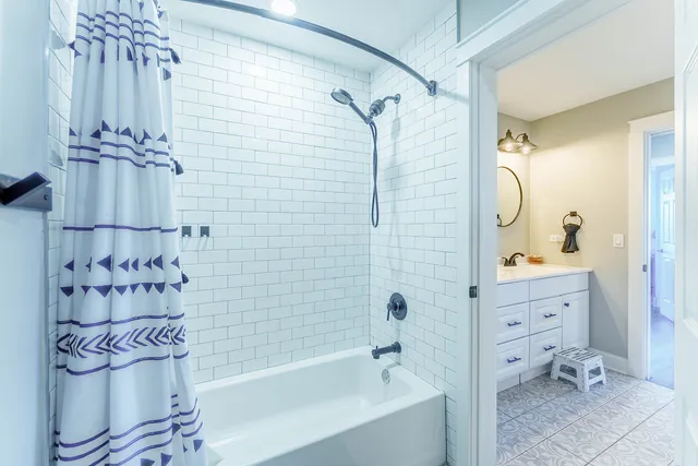 a bathroom with a bathtub a toilet and a shower