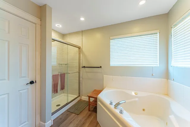 a bathroom with a bathtub and a shower