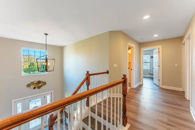 a view of hallway with livingroom and wooden floor
