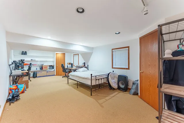 a bedroom with furniture and a flat screen tv