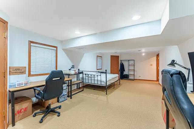 a view of a livingroom with workspace and a window