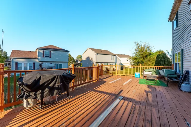 a view of a rooftop deck and patio with wooden floor