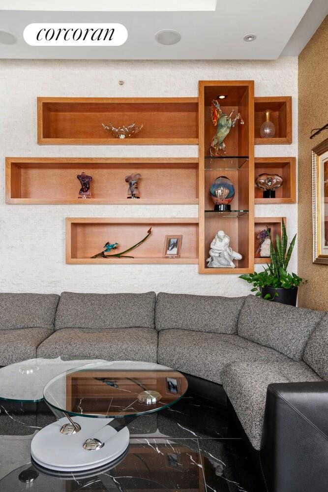 100 Riverside Boulevard, Unit PHB Manhattan, NY 10069 - Photo 10 of 34 a living room with furniture and a shelf