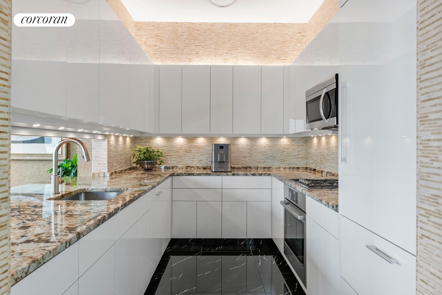 100 Riverside Boulevard, Unit PHB Manhattan, NY 10069 - Photo 8 of 34 a kitchen with granite countertop a sink stainless steel appliances and cabinets
