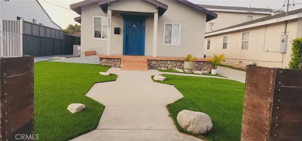 a view of an house with backyard space and patio