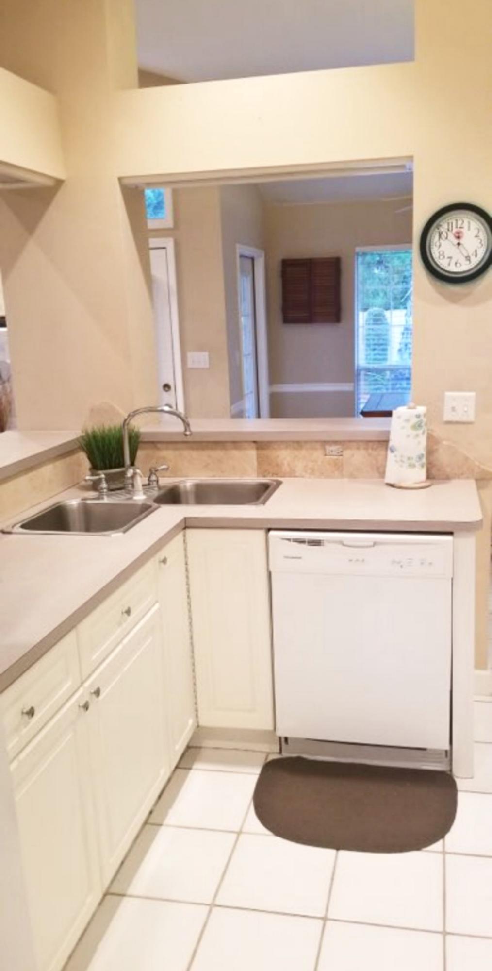 3911 Mesa Road Destin, FL 32541 - Photo 13 of 36 a kitchen with a sink a stove and cabinets