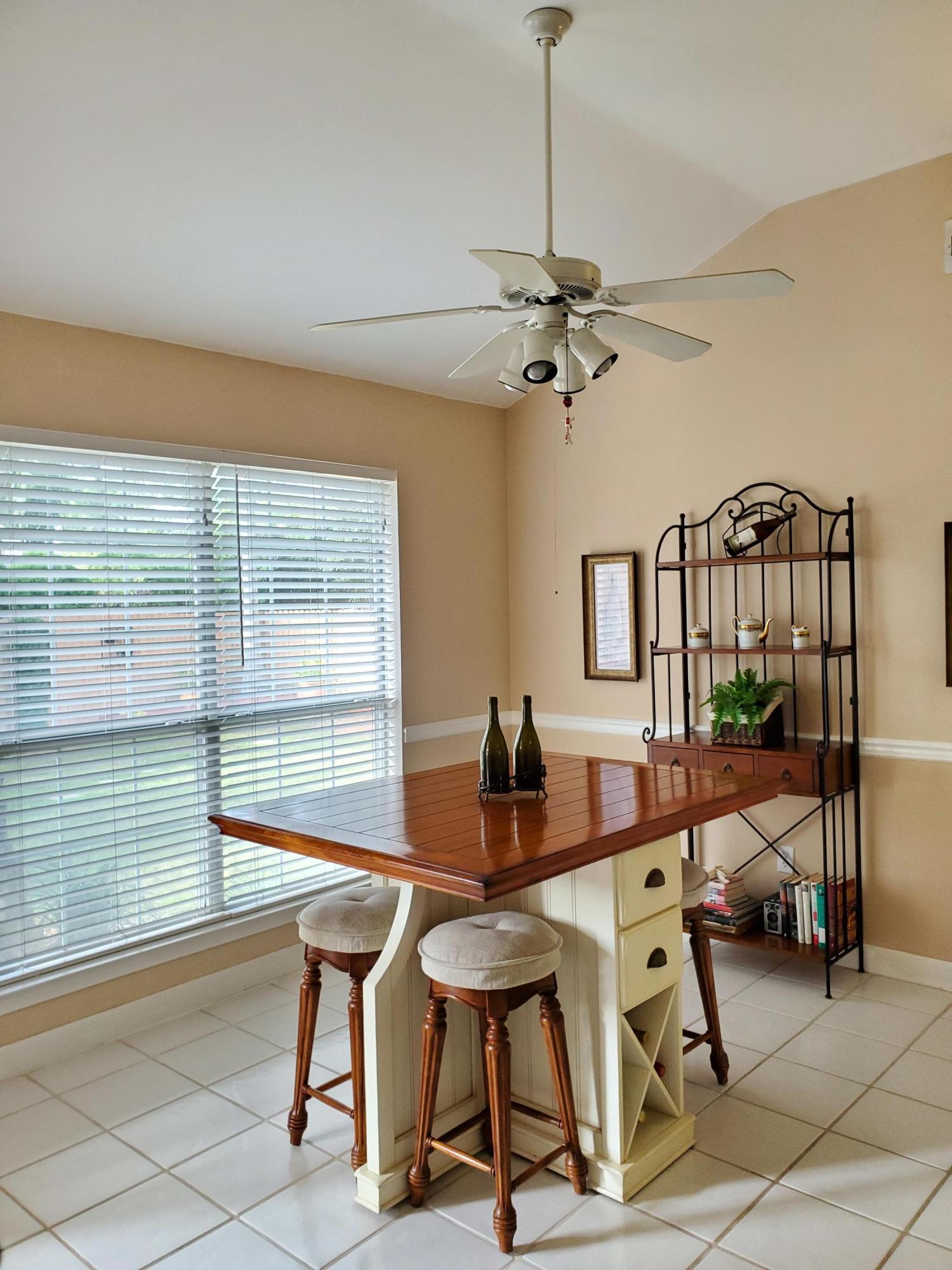3911 Mesa Road Destin, FL 32541 - Photo 14 of 36 a view of a dining room with furniture and a chandelier