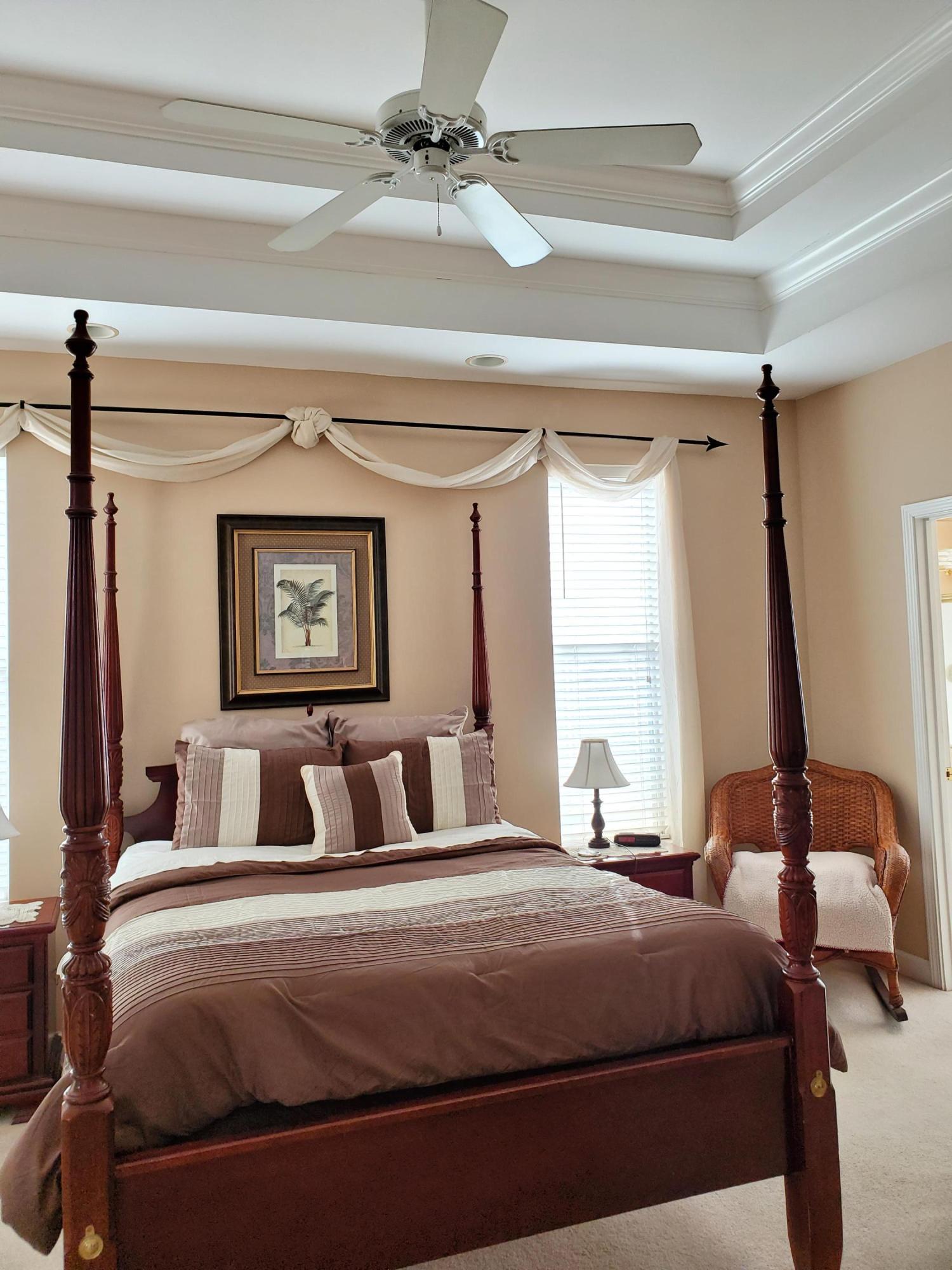 3911 Mesa Road Destin, FL 32541 - Photo 17 of 36 a bedroom with a large bed and a chandelier