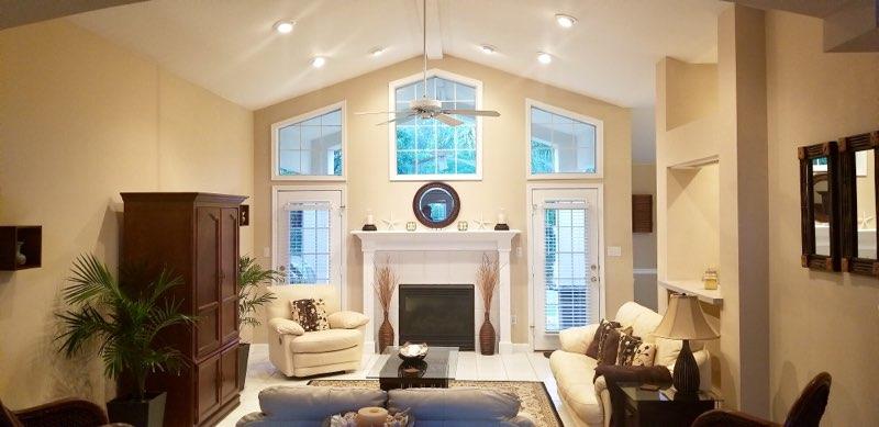 3911 Mesa Road Destin, FL 32541 - Photo 2 of 36 a living room with furniture a fireplace and a chandelier