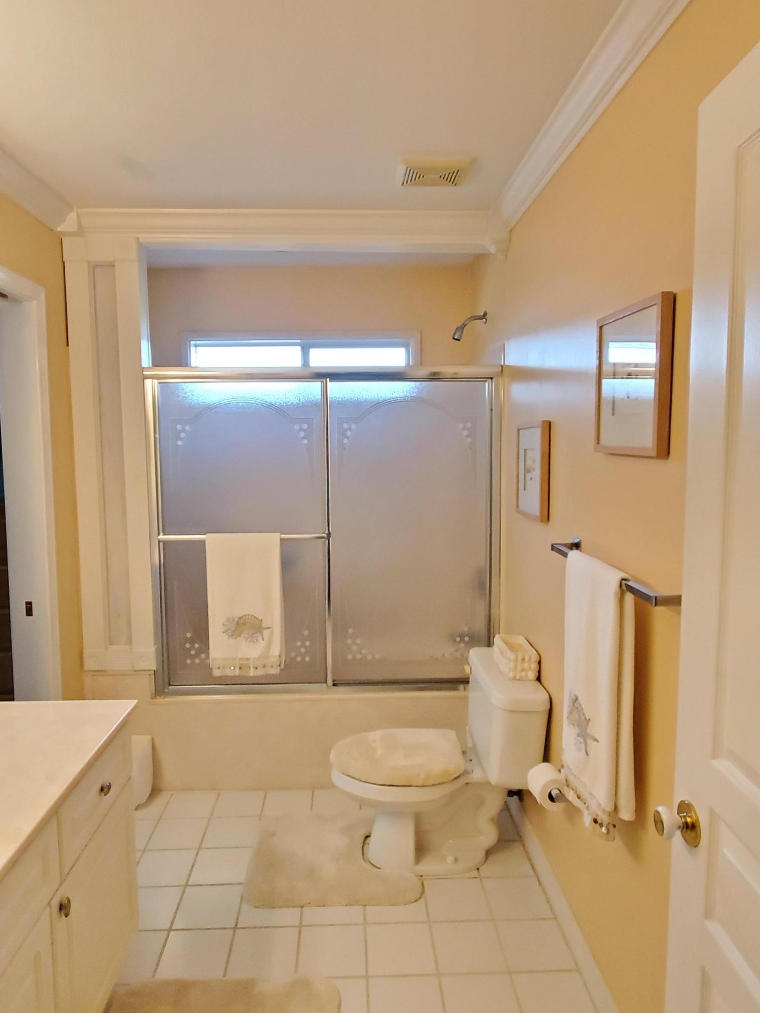 3911 Mesa Road Destin, FL 32541 - Photo 24 of 36 a bathroom with a granite countertop toilet sink and shower