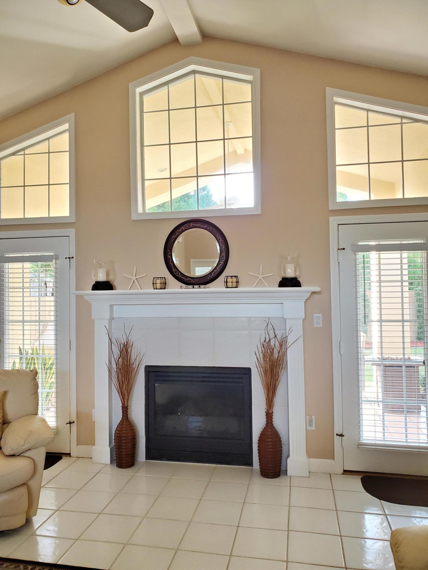 3911 Mesa Road Destin, FL 32541 - Photo 3 of 36 a living room with furniture a window and a fireplace