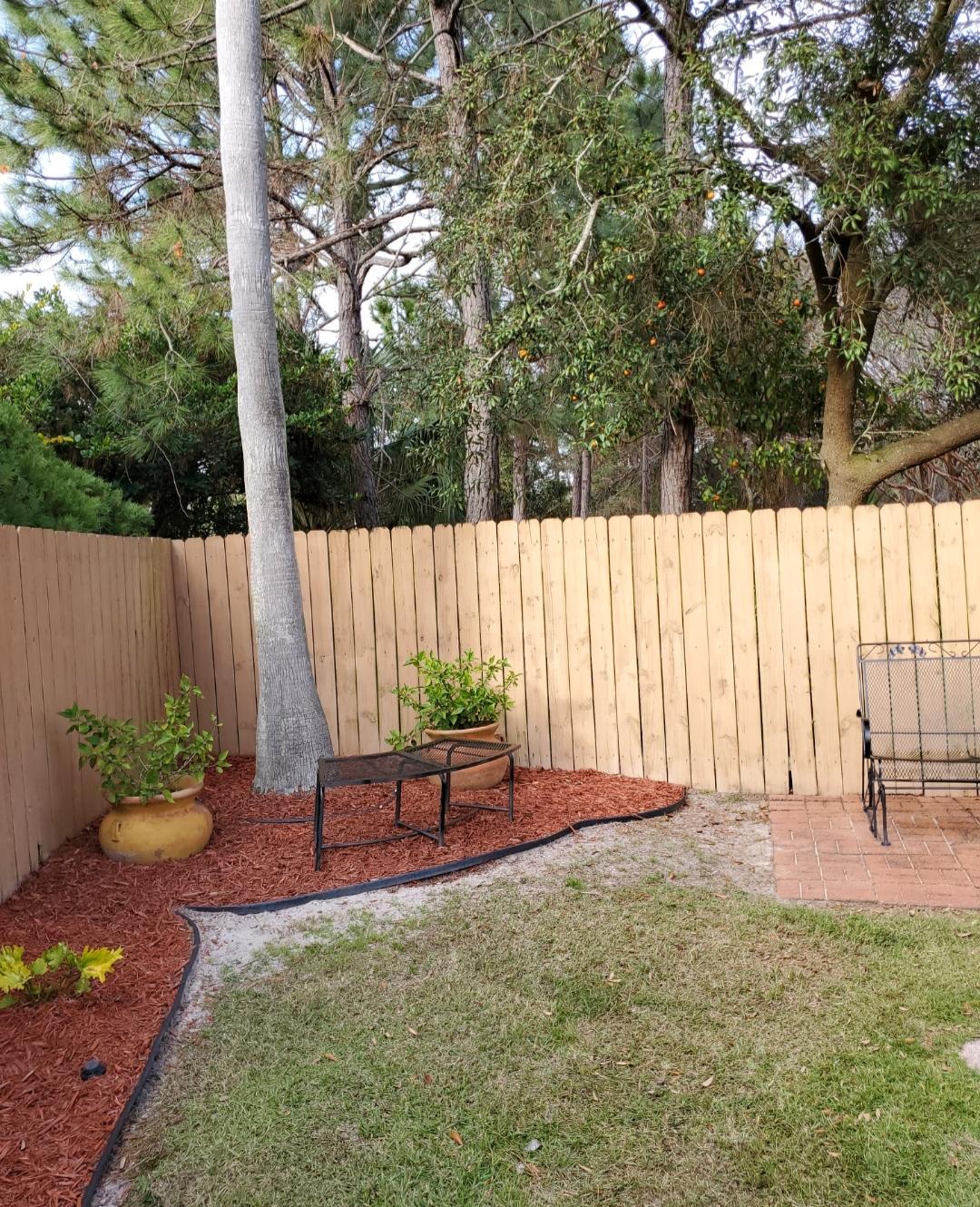 3911 Mesa Road Destin, FL 32541 - Photo 31 of 36 a backyard of a house with table and chairs