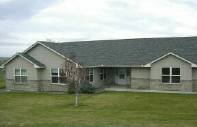 9440 Bittner Road Yakima, WA 98901 - Photo 1 of 8 a front view of a house with a garden