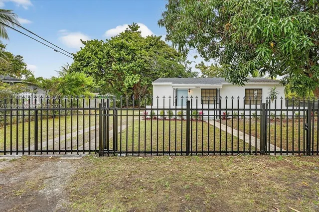 a view of a house with a wooden fence