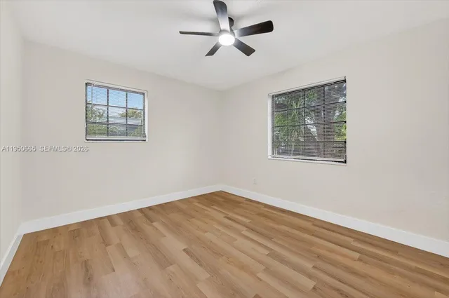a view of empty room with ceiling fan