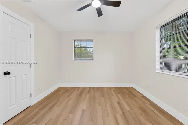wooden floor in an empty room with a window