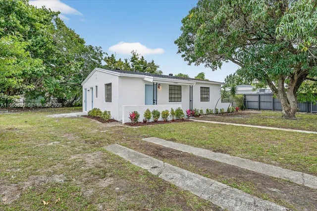 a front view of house with yard and green space