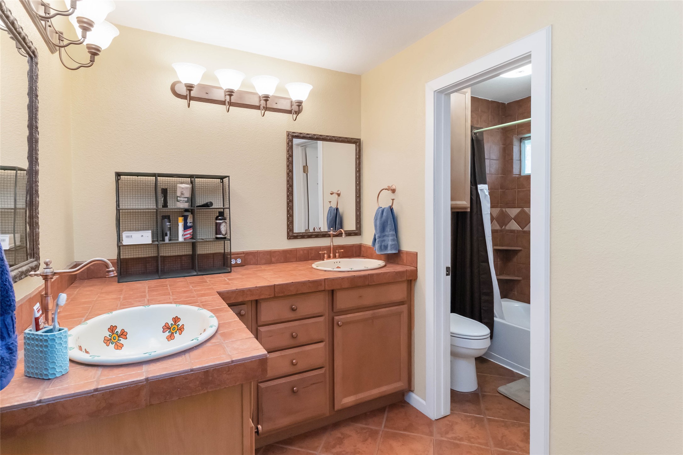 1208 Jeddo Road Rosanky, TX 78953 - Photo 19 of 40 Dual vanity with custom sinks and ample storage, complementing the adjoining full bath with a tiled shower.