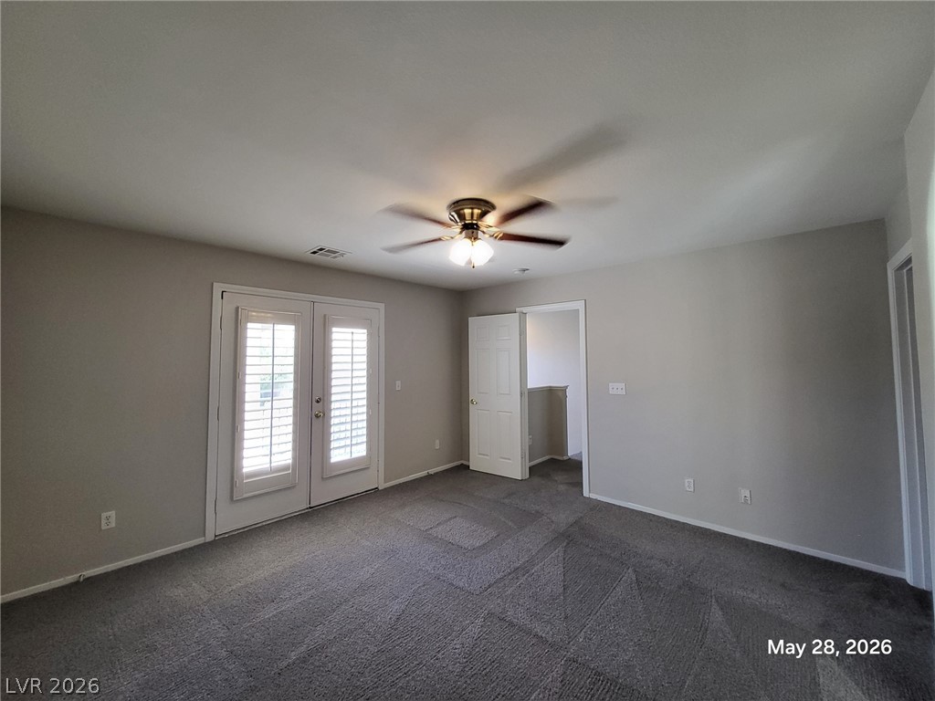 9843 West Overlook Ridge Avenue Las Vegas, NV 89148 - Photo 13 of 19 Dual French doors invite abundant natural light into this adaptable secondary bedroom.