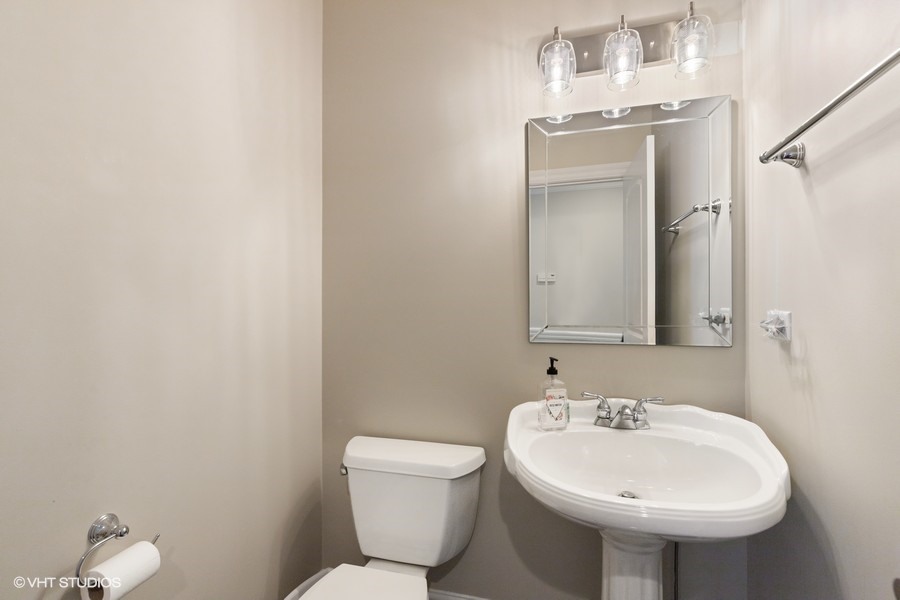 1032 Mar Ln Drive Lake Forest, IL 60045 - Photo 16 of 22 a bathroom with a sink a toilet and mirror