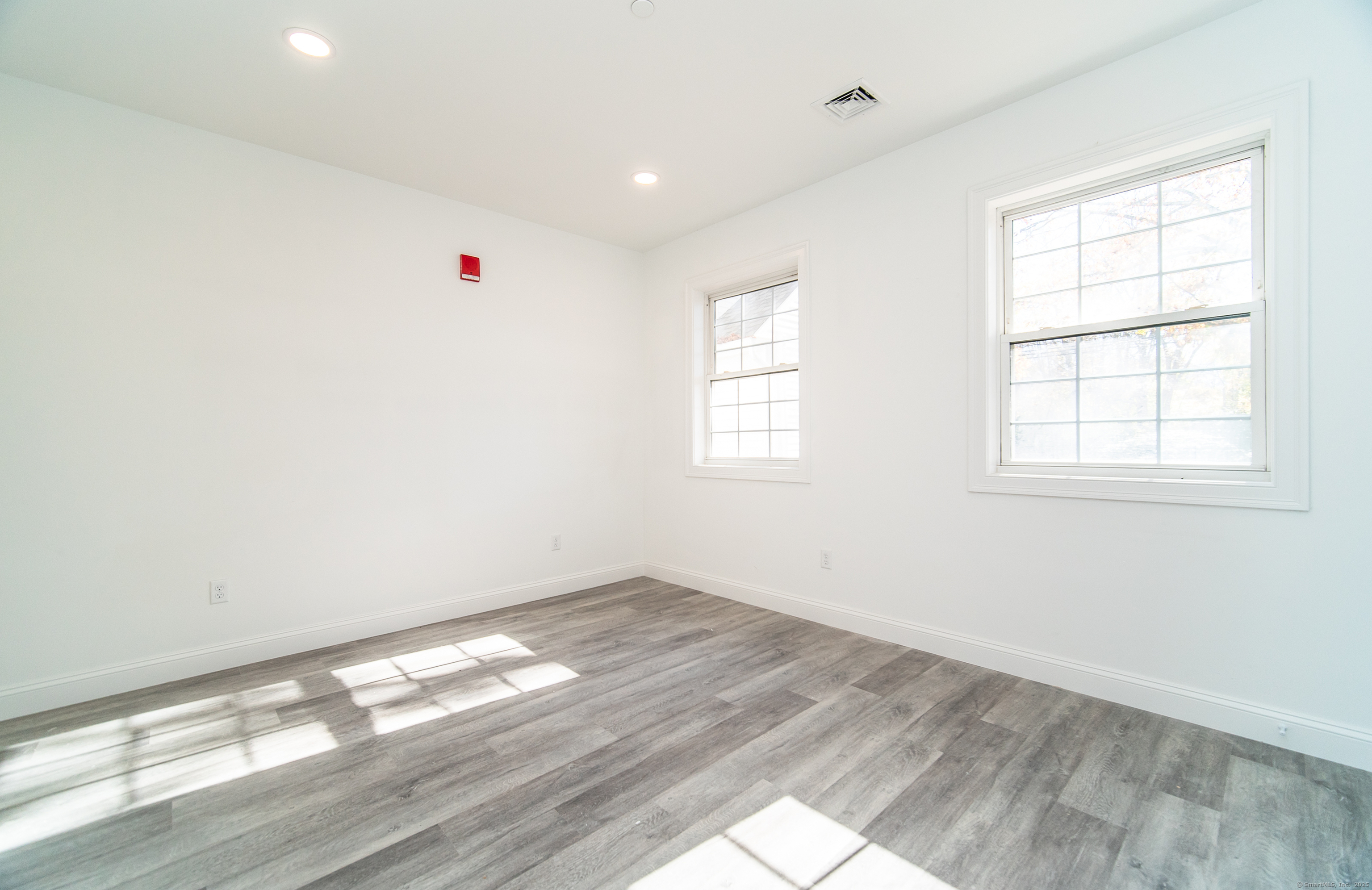 1154 Poquonnock Road, Unit 3 Groton, CT 06340 - Photo 12 of 17 an empty room with wooden floor and windows