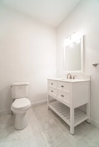 a bathroom with a sink toilet and mirror