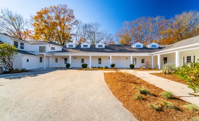 a front view of a house with a yard and a garage