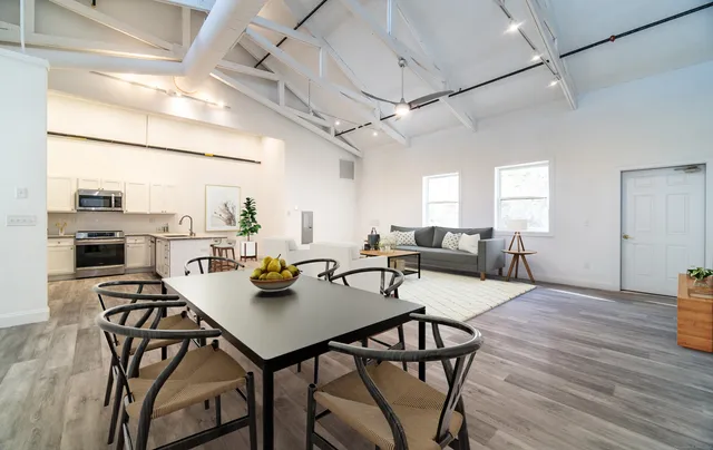 a view of a dining room with furniture and wooden floor