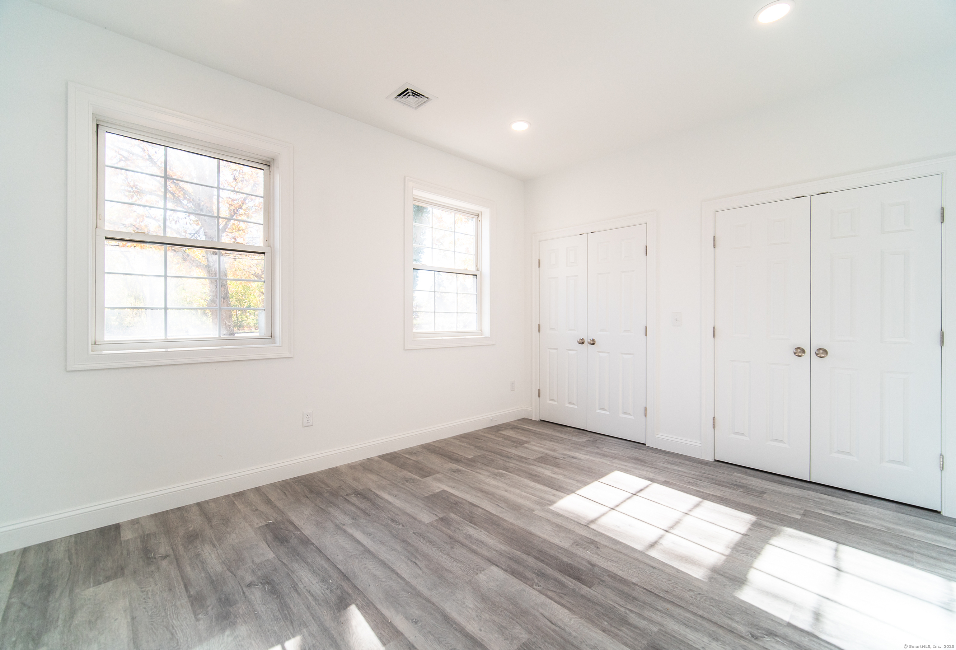 1154 Poquonnock Road, Unit 3 Groton, CT 06340 - Photo 10 of 17 a view of empty room with wooden floor and fan