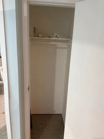 a view of a kitchen with kitchen island a sink wooden floor and a large refrigerator