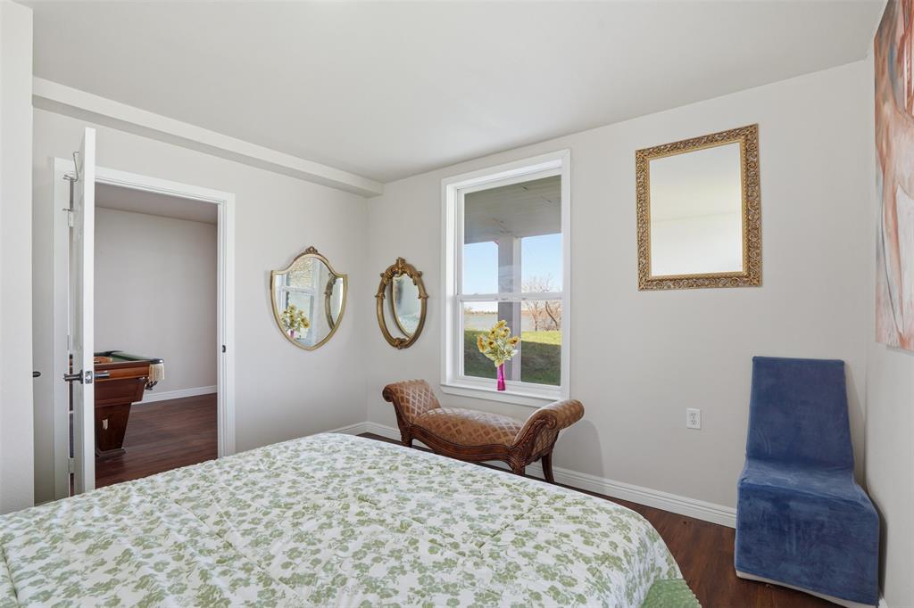 13280 Beach Club Road The Colony, TX 75056 - Photo 28 of 40 a bedroom with a bed and wooden floor