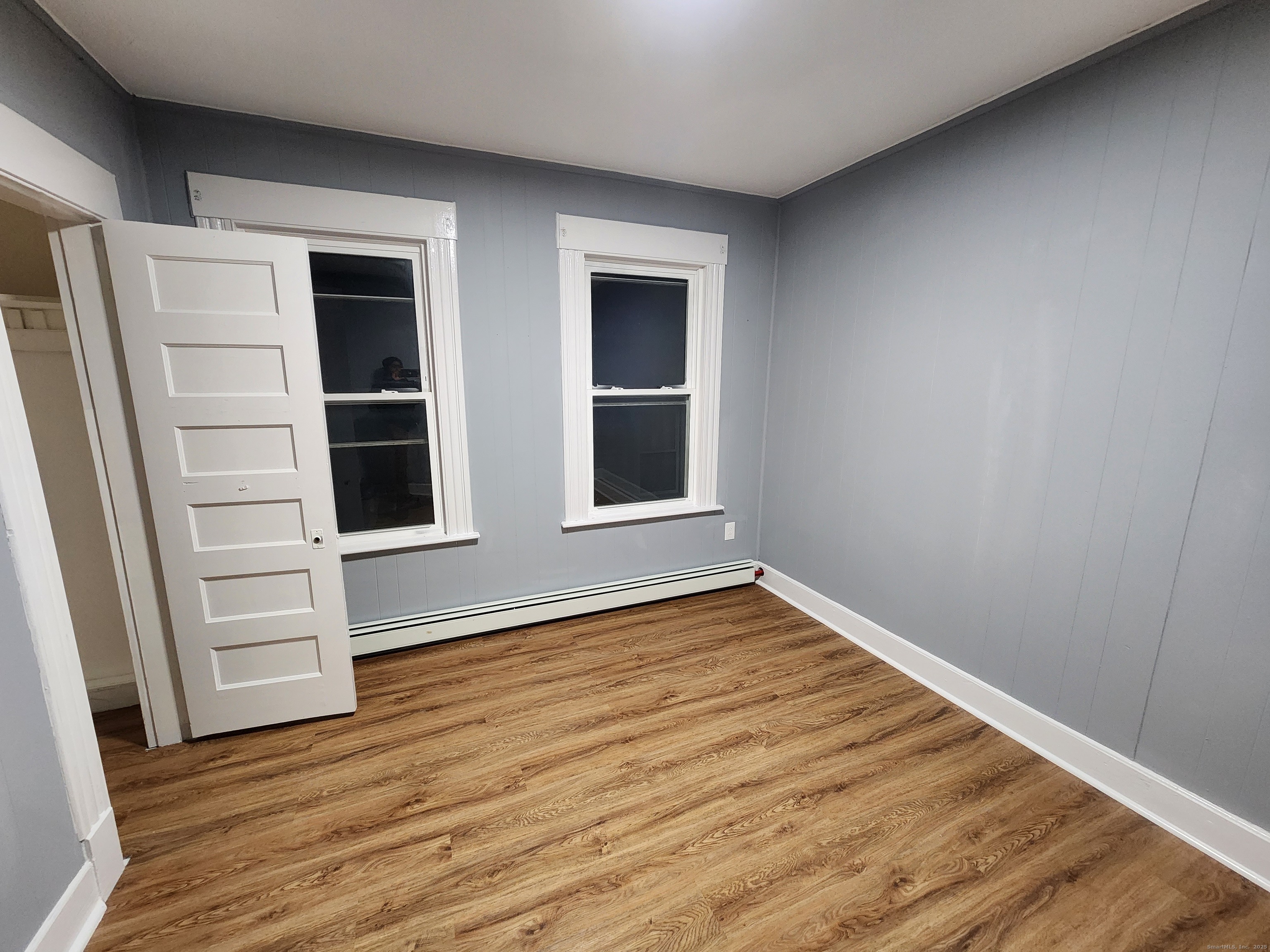 19 Sprague Street Waterbury, CT 06704 - Photo 3 of 12 a view of an empty room with wooden floor and window
