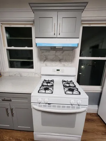 a stove top oven sitting inside of a kitchen