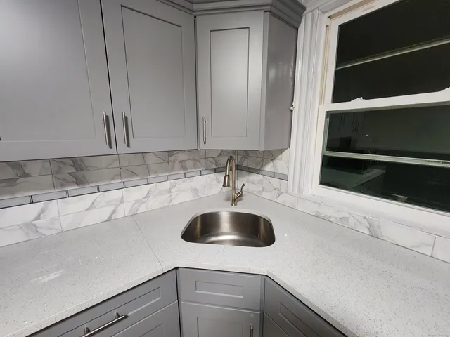 a kitchen with a sink and cabinets