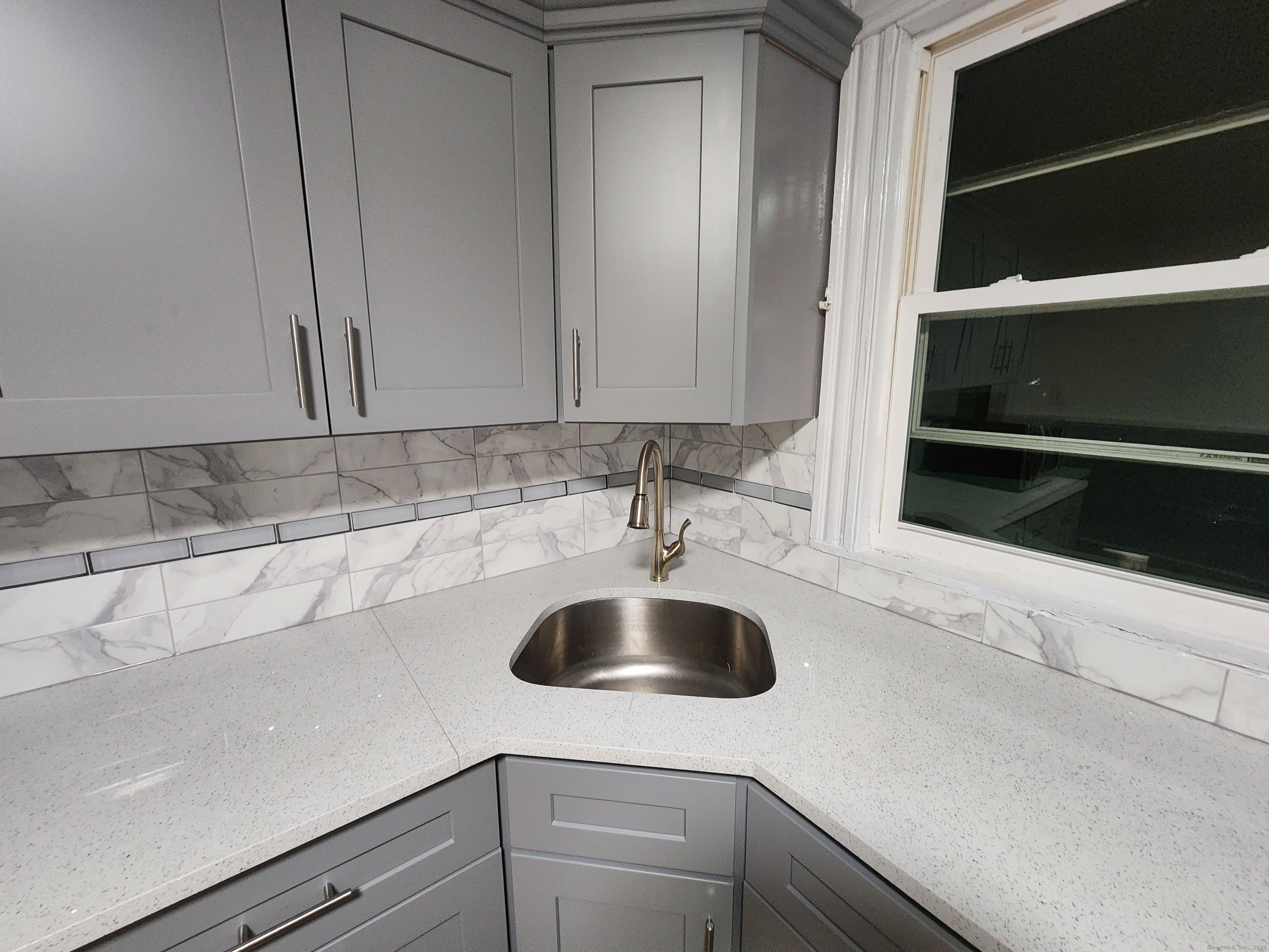 19 Sprague Street Waterbury, CT 06704 - Photo 7 of 12 a kitchen with a sink and cabinets