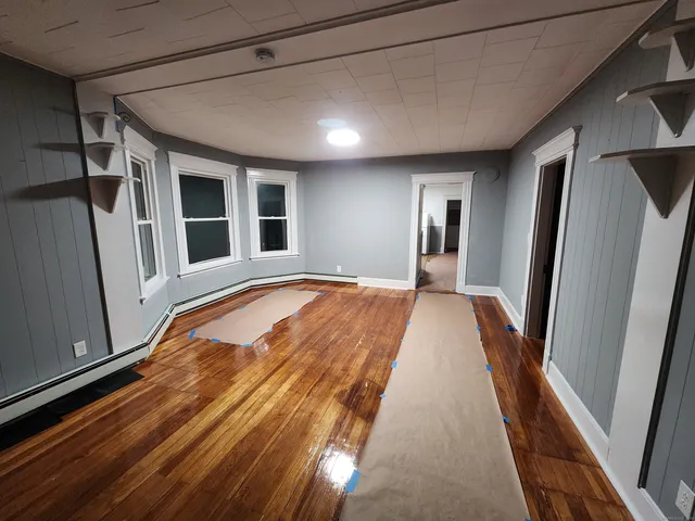 a view of a hall with wooden floor