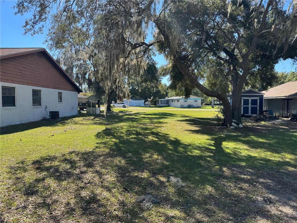 Tbd Southwest 97th Street Ocala, FL 34476 - Photo 4 of 6 a view of a swimming pool with lawn chairs under an umbrella