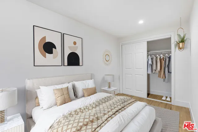 a bedroom with a bed and a painting on the wall