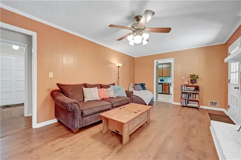 a living room with furniture and wooden floor