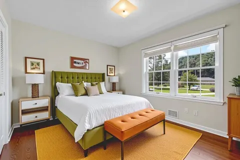 a bedroom with a bed a couch and a window