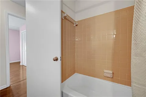 a bathroom with a shower and a bath tub