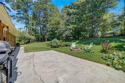 a view of backyard with seating area and green space