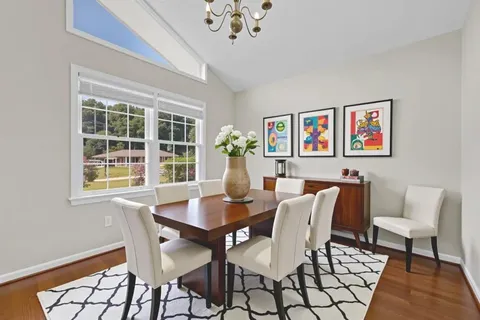a view of a dining room with furniture wooden floor and a chandelier