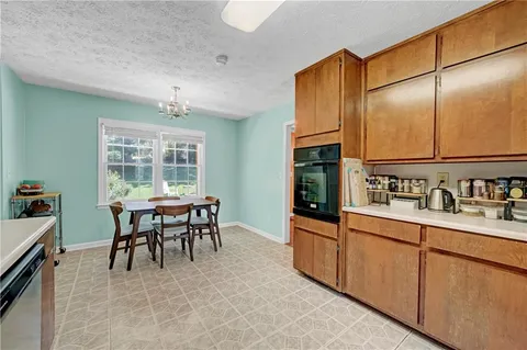 a kitchen with granite countertop cabinets a sink and appliances