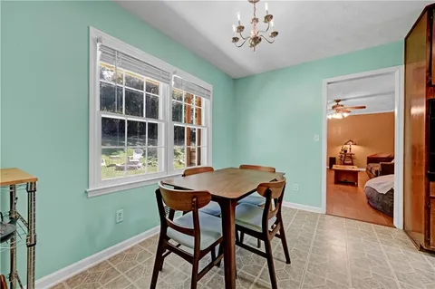 a dining room with furniture and window