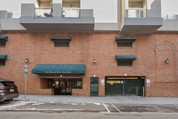 a view of a brick building with many windows