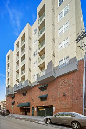 a front view of a building with parking space