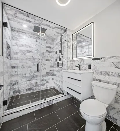a bathroom with a sink toilet and shower